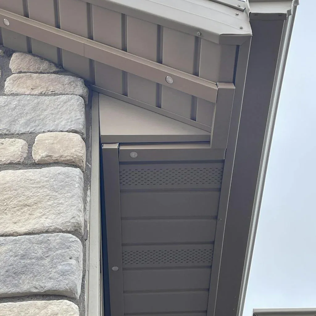 Color-matched bronze aluminum lighting track installed flush under eaves blending seamlessly into exterior trim